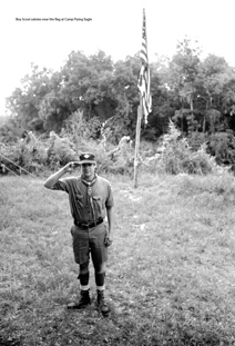  Boy Scout salutes near the flag at Camp Flying Eagle.tif